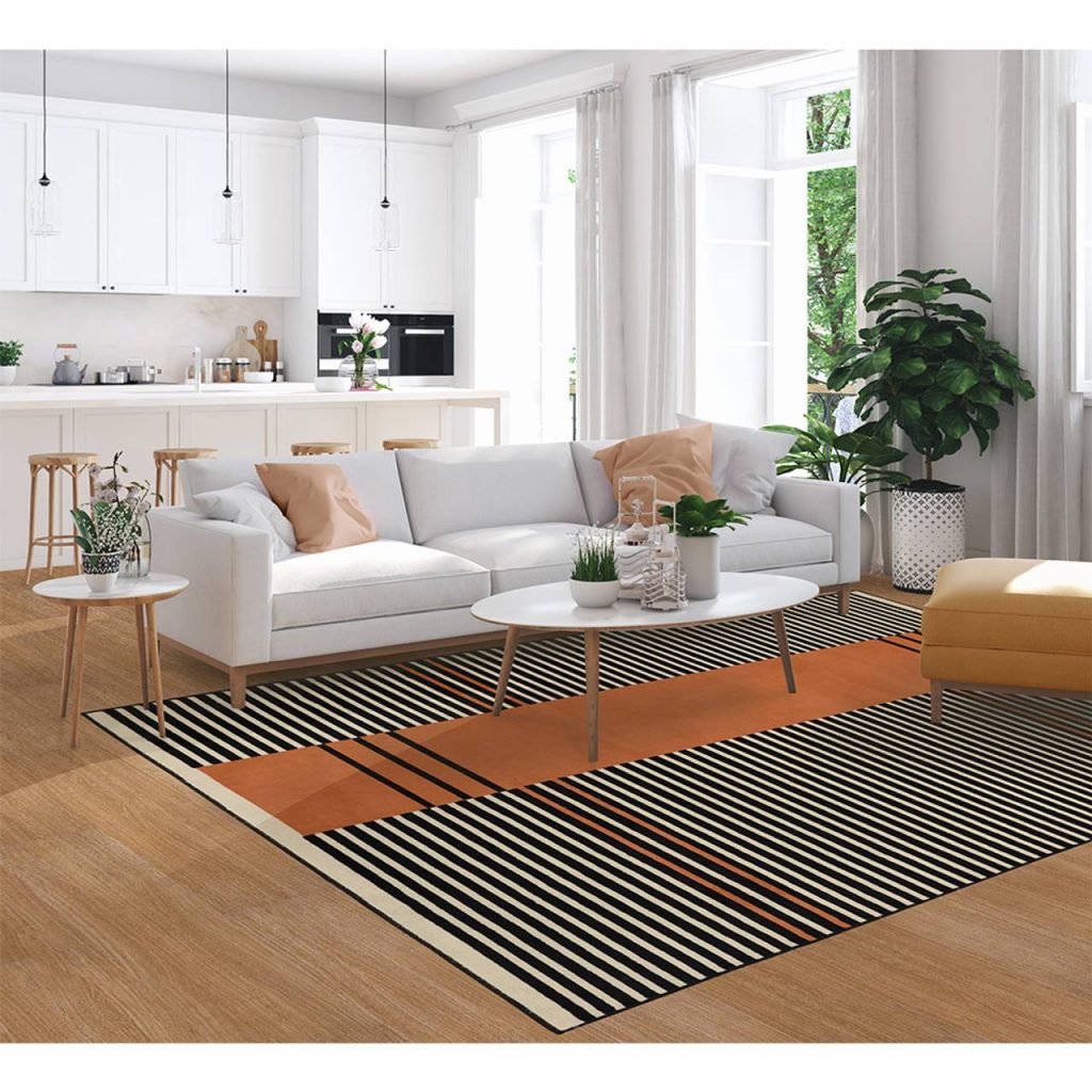 Sala de estar integrada com a cozinha e um tapete na sala é uma boa opção de decoração de apartamento alugado